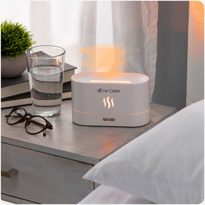 white essential oil diffuser on night stand