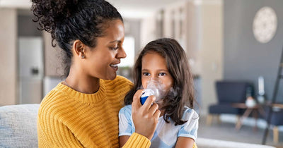 Mother helping her child with an asthma inhaler.