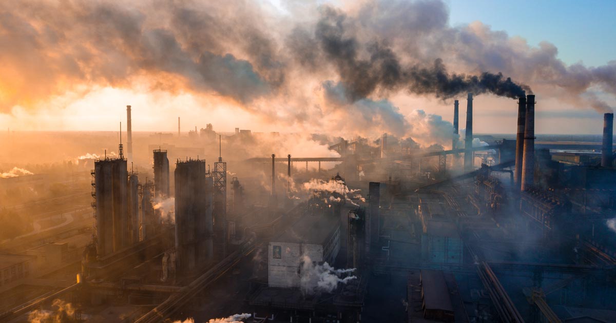 Skyline photo of factories spewing polluted air from their chimneys