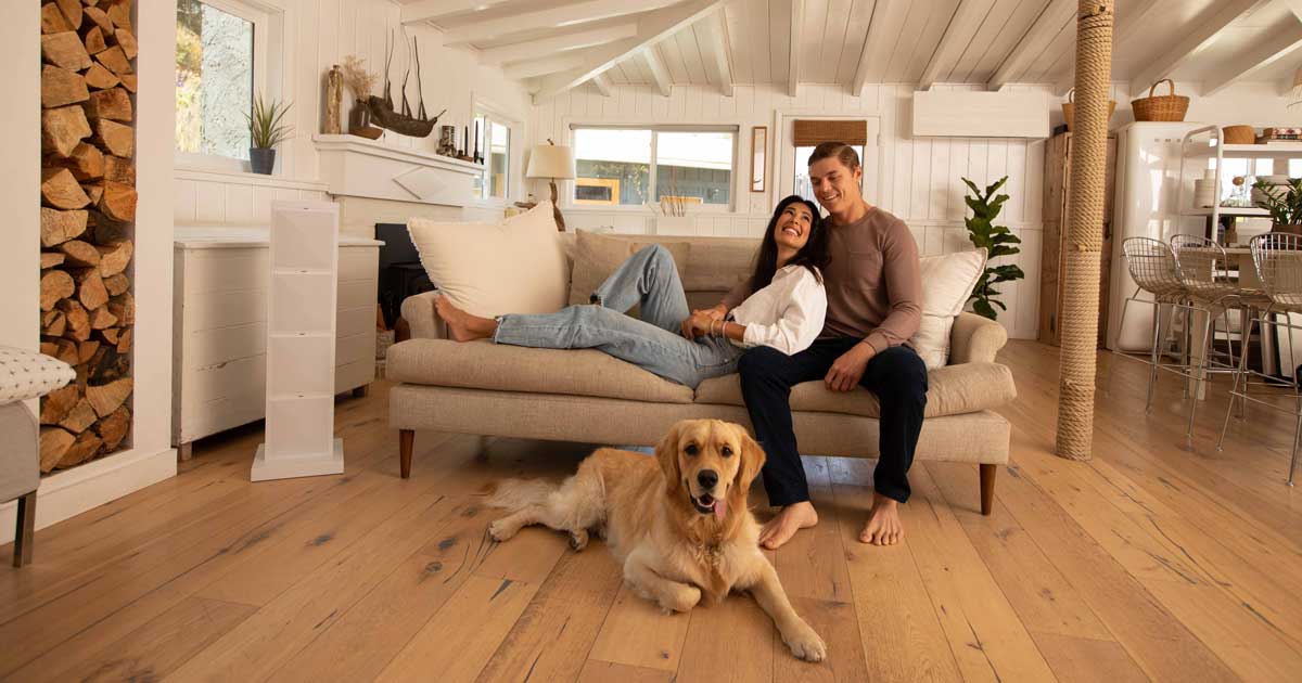 Couple sitting in their great room with the family dog
