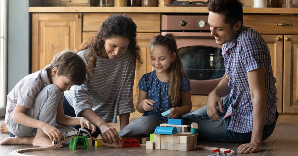 Family sitting together playing with toy bricks