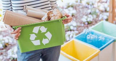 Woman taking out a bin of recycling